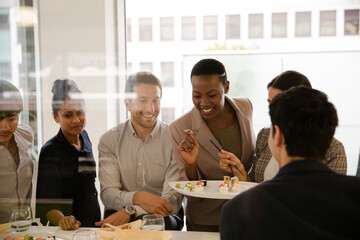 Business people enjoying sushi lunch