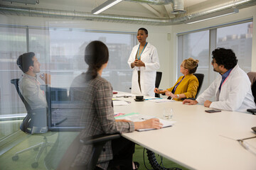 Businesswoman leading conference room meeting