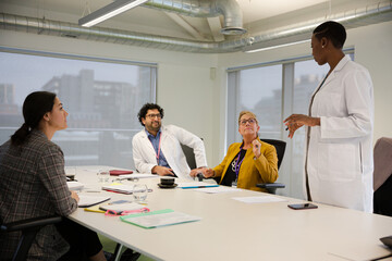 Businesswoman leading conference room meeting