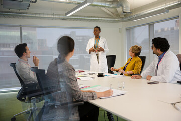 Businesswoman leading conference room meeting