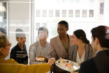 Business people enjoying sushi lunch