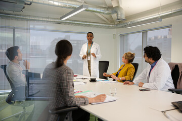 Businesswoman leading conference room meeting