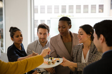 Business people enjoying sushi lunch