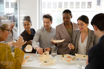 Business people enjoying sushi lunch in conference room