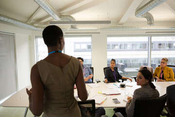 Businesswoman leading conference room meeting