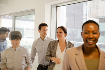 Smiling business people leaving conference room