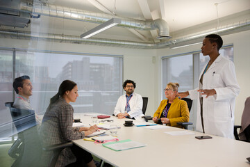 Businesswoman leading conference room meeting
