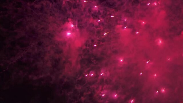 Fireworks Festival Background. Shining Real Fireworks With Bokeh Lights In The Night Sky. Glowing Fireworks Show. New Year's Eve Fireworks Celebration Holiday. Colorful Firework Flashes At Night 4K