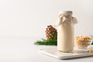 Vegan cedar milk on a white background with copy space. Alternative milk replacer. Dietary product.