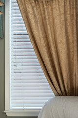 Gold Pattern Curtain on Window with White Wood Blinds