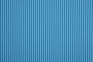 Closeup of blue striped perforated paper background