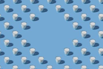 World Milk Day. Pattern on a blue background. A glass of milk. Sample. With space for text. copy space