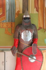 Armor of a medieval warrior in chain mail with a sword and shield