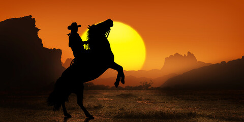 Cowboy on horseback at sunset © ginettigino