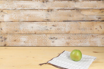Empty wooden table with green apple on old background with place for text, rustic style, healthy...