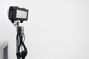 Filming light equipment with long cables with blank wall.