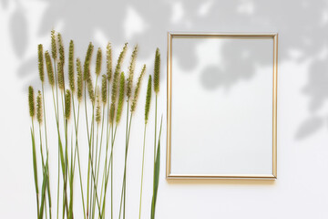 Summer composition with A4 blank silver frame with blank space, summer field plants and shadow overlay.