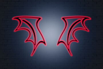 Obraz premium neon red wings on a brick wall background