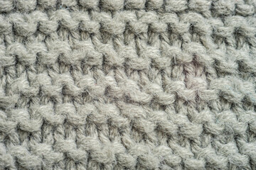 Pale grey background of knitted thread pattern