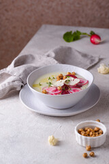 Cauliflower soup puree decorated with radish