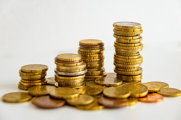 Stacks of euro coins placed on white surface. Money and value of money.
