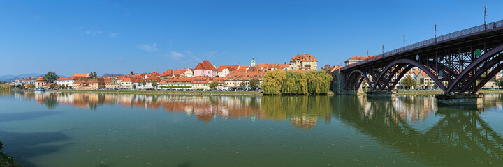 Fototapeta na wymiar Maribor, Slovenia. Panorama of historical part of the city from the shore of Drava river. Maribor is the second-largest city in Slovenia and the largest city of the traditional region of Lower Styria.