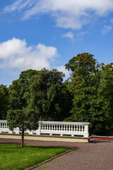 Fototapeta na wymiar Landscape in Kadriorg park. Green trees on the back. White barocco style handrails. Summer sunny day. Green grass. Tallinn, Estonia, Europe. August 2021