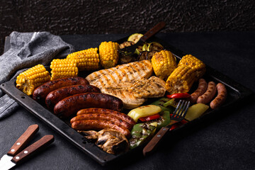 Grilled sausages, meat, and vegetables.