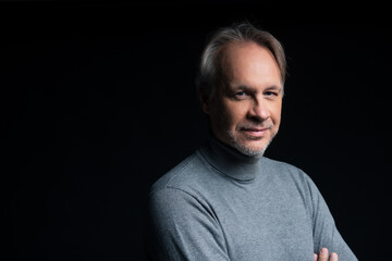 Attractive mature man with beard on plain background wearing casual 