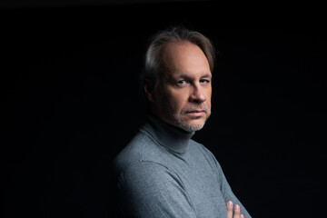 Attractive mature man with beard on plain background wearing casual 