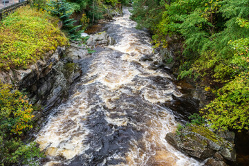View of Clunie Water river in Aberdeenshire, Scotland. It is a tributary of the River Dee, joining...