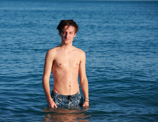 A portrait of a young fit caucasian male in the sea