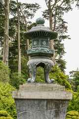 USA, California, San Francisco - May 19, 2008: Japanese Garden. Green bronze lantern statue on gray...
