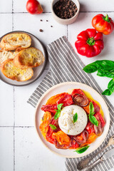Burrata cheese with baked tomatoes, pepper, red onion and fresh basil