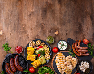 Grilled sausages, meat, and vegetables.