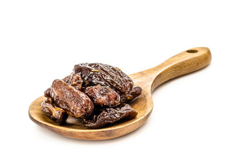 Brazilian prunes in rustic wooden spoon , isolated white background .