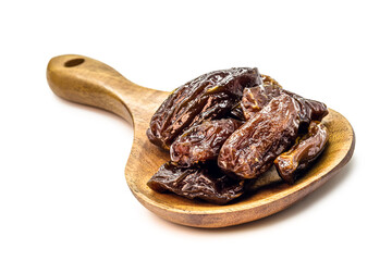 Brazilian prunes in rustic wooden spoon , isolated white background .