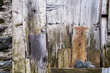 texture of a wooden door with different types of wood in poor condition and affected by woodworm, horizontal