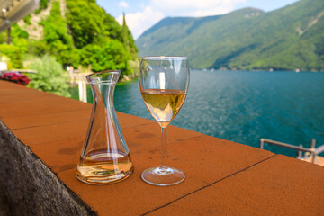 rose wine by the lakefront of Lugano city in Switzerland. Romantic appetizer in Ticino Canton on...