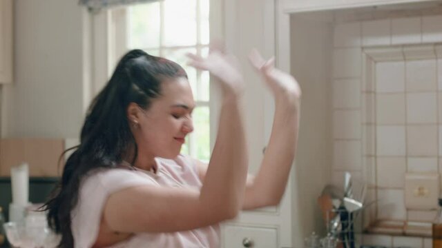 Happy Overweight Teenage Girl Dancing In Kitchen Having Fun Celebrating Weekend Performing Funny Dance Moves At Home Enjoying Weekend Celebration