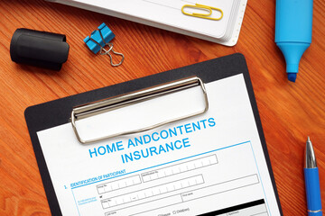 Financial concept meaning HOME ANDCONTENTS INSURANCE with sign on the financial document