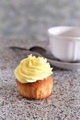 Closeup cup of tea and yellow cupcake dessert baked delicious pastry tea time 