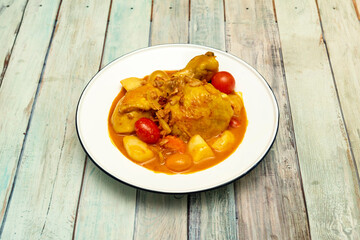 Spicy Yellow Chicken Curry Cooked by a Thai Chef with Cherry Tomatoes, Grapes and Stewed Potatoes