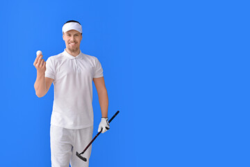 Handsome male golfer on color background