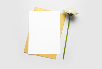 Blank card and flower on white background