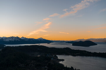 View of the Nahuel Huapi National Park at sunset. Orange sky, lakes and mountains of San Carlos de...