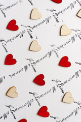 wooden hearts - some hand painted red - on a white background with the french words "monsieur" and "je t'aime"