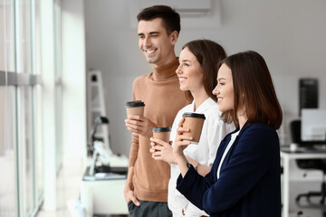 Business colleagues drinking coffee in office