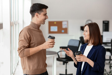 Business colleagues drinking coffee in office