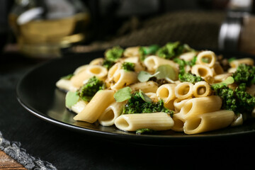 Plate with tasty pasta and pesto sauce on table, closeup